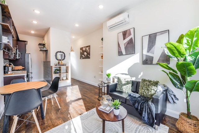 living room with dark wood-style floors, recessed lighting, baseboards, and a wall unit AC