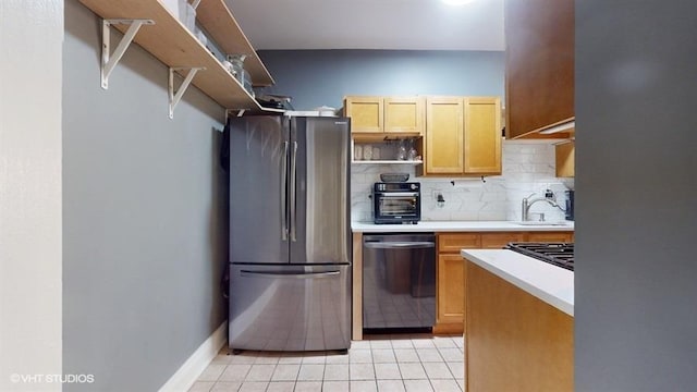 kitchen featuring appliances with stainless steel finishes, backsplash, light brown cabinetry, sink, and light tile patterned flooring