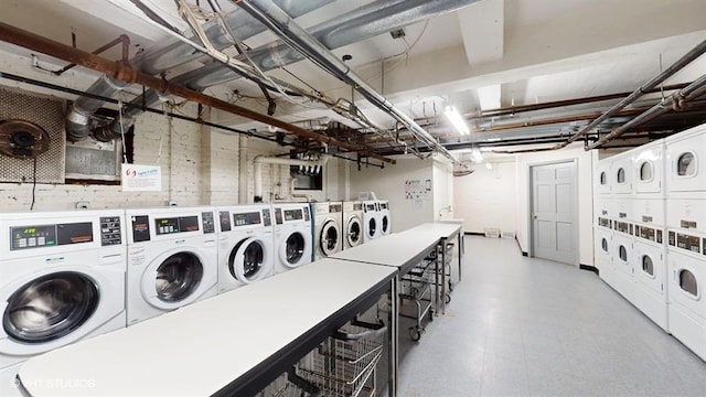 washroom with stacked washing maching and dryer and washing machine and clothes dryer