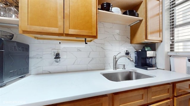 kitchen featuring decorative backsplash and sink