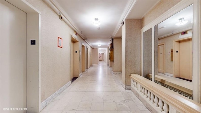 hallway with crown molding and elevator