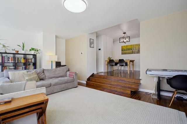 living room featuring dark wood-type flooring and a notable chandelier