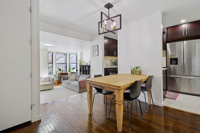 dining space with an inviting chandelier and dark hardwood / wood-style flooring