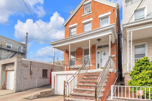 9 E 15th St, Bayonne, NJ 07002 - traditional home with brick siding, a garage, a porch, and driveway