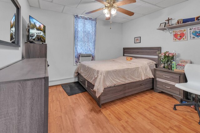 9 E 15th St, Bayonne, NJ 07002 - bedroom with a paneled ceiling, baseboard heating, light wood-style flooring, and ceiling fan