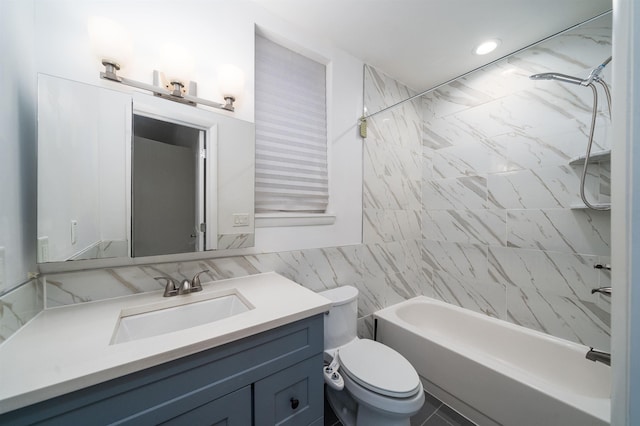 full bathroom with tile walls, toilet, vanity, and shower / tub combination