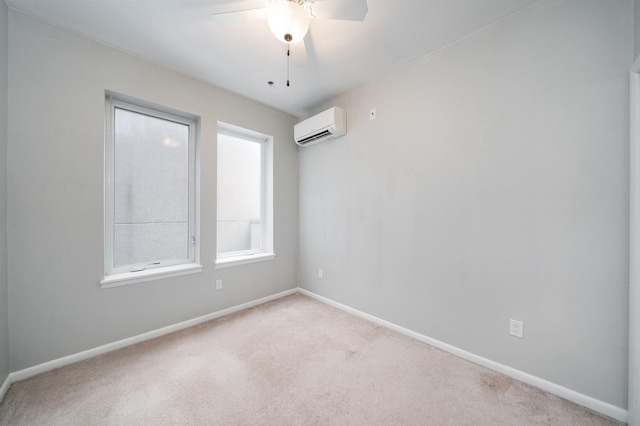 carpeted spare room featuring ceiling fan, baseboards, and an AC wall unit