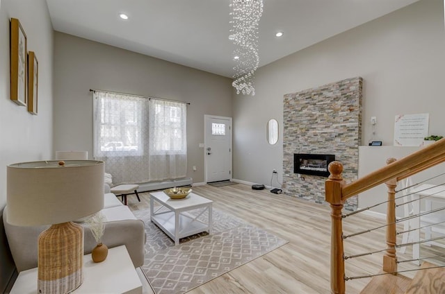 living room featuring a notable chandelier, hardwood / wood-style flooring, and a fireplace