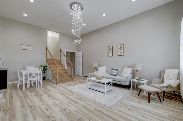 living room with a chandelier and light hardwood / wood-style flooring