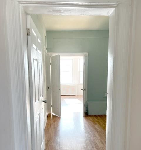 hallway with hardwood / wood-style flooring