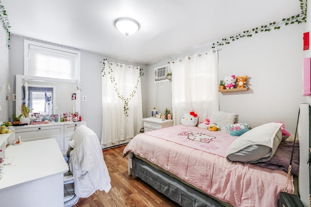 bedroom featuring an AC wall unit and dark wood-type flooring