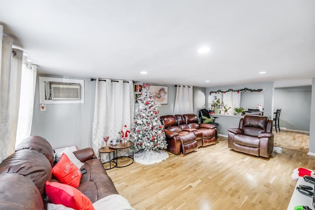 living room with hardwood / wood-style flooring and a wall mounted air conditioner