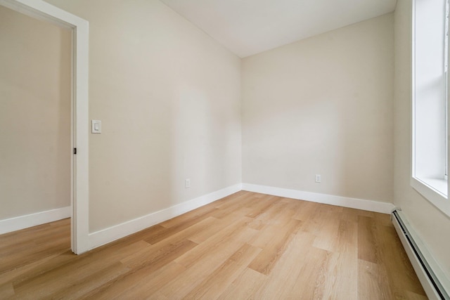 450 1st St Unit 2, Hoboken, NJ 07030 - spare room with baseboard heating, light wood-style floors, baseboards, and vaulted ceiling