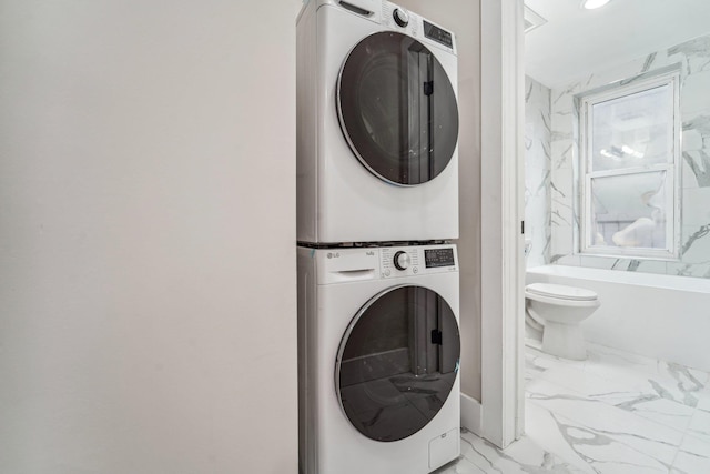 450 1st St Unit 2, Hoboken, NJ 07030 - washroom featuring stacked washer / drying machine and light marble finish flooring