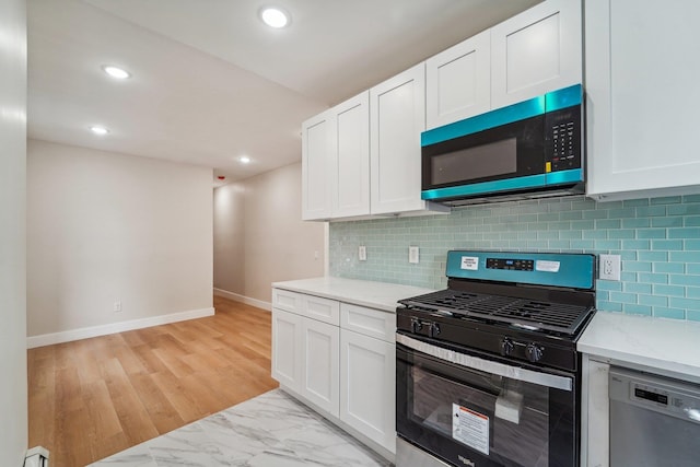 450 1st St Unit 2, Hoboken, NJ 07030 - kitchen featuring gas range, dishwashing machine, white cabinetry, baseboards, and recessed lighting