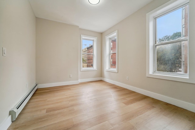 450 1st St Unit 2, Hoboken, NJ 07030 - spare room with a baseboard radiator, light wood-style floors, and baseboards