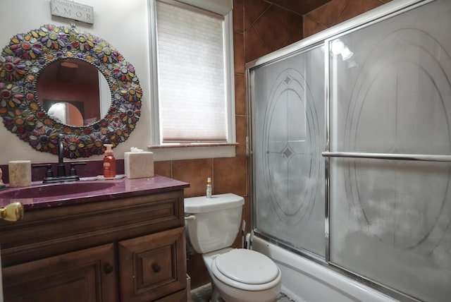 7502 Cottage Ave, North Bergen, NJ 07047 - full bathroom with vanity, combined bath / shower with glass door, toilet, and tile walls
