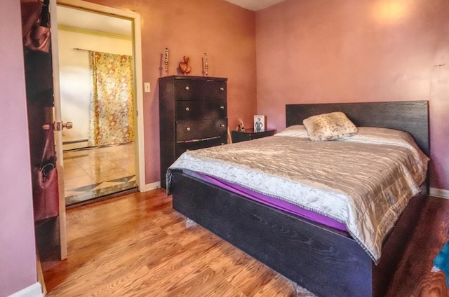 7502 Cottage Ave, North Bergen, NJ 07047 - bedroom featuring wood finished floors, baseboards, and a baseboard heating unit