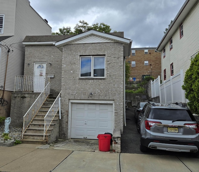 7502 Cottage Ave, North Bergen, NJ 07047 - view of front of property featuring an attached garage, brick siding, and driveway