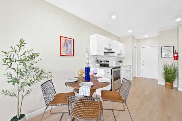 82 E 24th St, Bayonne, NJ 07002 - dining space featuring light wood finished floors, baseboards, and recessed lighting