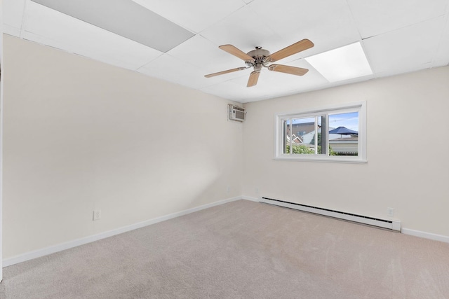 82 E 24th St, Bayonne, NJ 07002 - carpeted spare room with a baseboard radiator, ceiling fan, baseboards, a wall mounted air conditioner, and a paneled ceiling