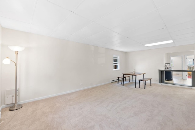 82 E 24th St, Bayonne, NJ 07002 - basement featuring a paneled ceiling, carpet flooring, and baseboards