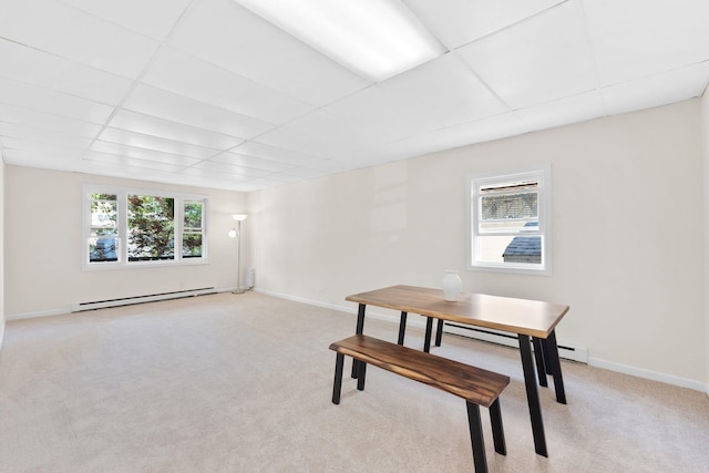 82 E 24th St, Bayonne, NJ 07002 - dining room with light colored carpet, a drop ceiling, baseboards, and a baseboard heating unit