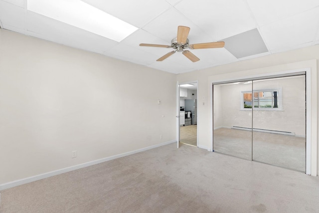 82 E 24th St, Bayonne, NJ 07002 - unfurnished bedroom with a baseboard heating unit, carpet floors, baseboards, ceiling fan, and a closet