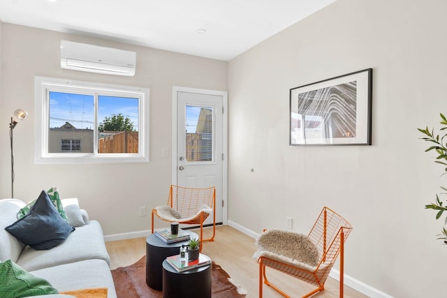82 E 24th St, Bayonne, NJ 07002 - living area featuring a wall mounted air conditioner, wood finished floors, and baseboards