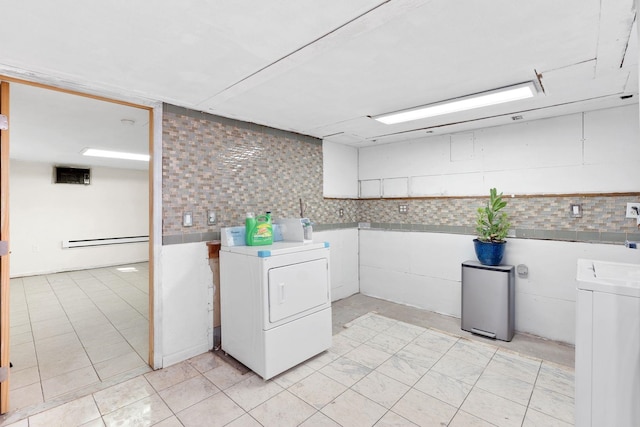 82 E 24th St, Bayonne, NJ 07002 - laundry room with baseboard heating and light tile patterned floors