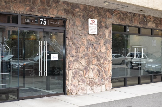 view of exterior entry featuring stone siding