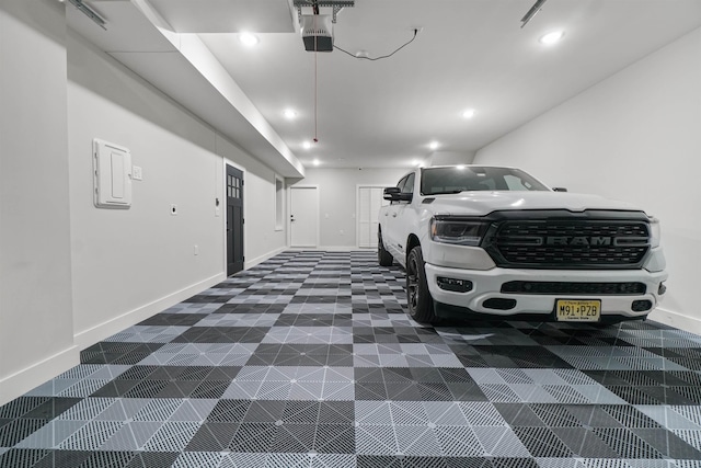 garage with recessed lighting, baseboards, and a garage door opener