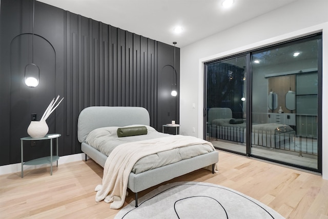 bedroom featuring light wood finished floors, access to exterior, and recessed lighting