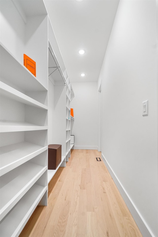 walk in closet featuring light wood finished floors and visible vents