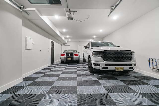 garage featuring a garage door opener, recessed lighting, and baseboards