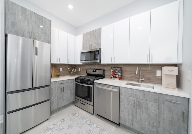 21 Hancock Ave Unit 1, Jersey City, NJ 07307 - kitchen with stainless steel appliances, light countertops, backsplash, gray cabinets, and recessed lighting