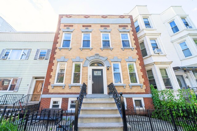 21 Hancock Ave Unit 1, Jersey City, NJ 07307 - townhome / multi-family property featuring brick siding, a fenced front yard, and a gate