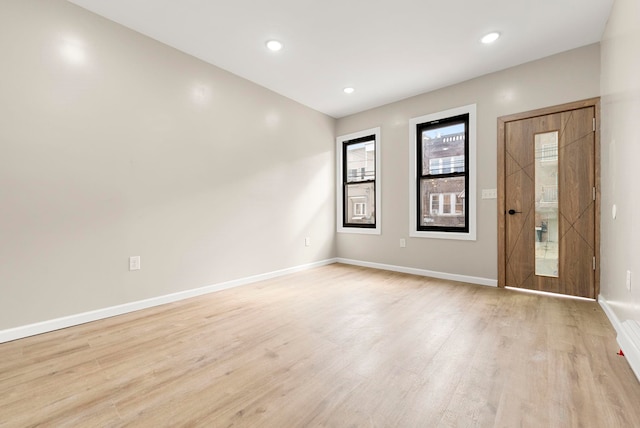 foyer with light wood finished floors, recessed lighting, and baseboards