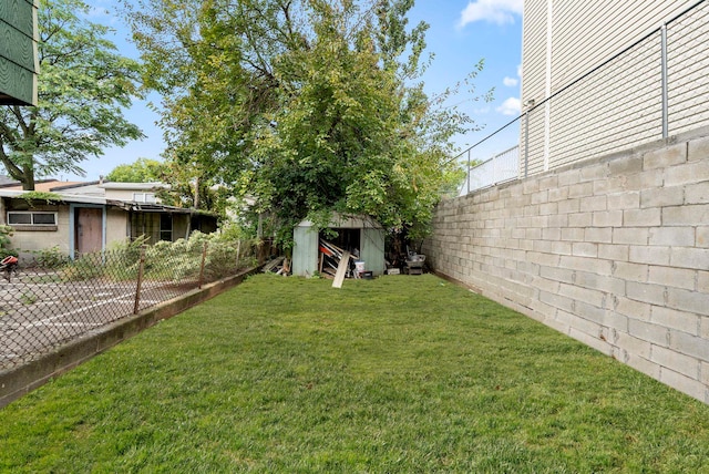 view of yard featuring an outdoor structure, a storage shed, and a fenced backyard