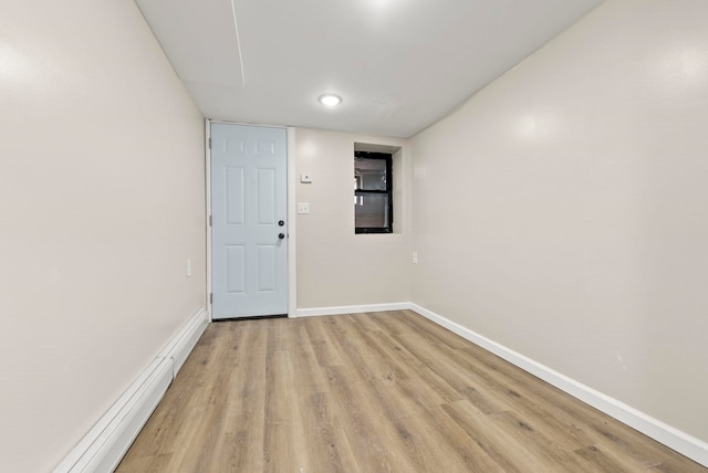 unfurnished room with baseboards and light wood finished floors