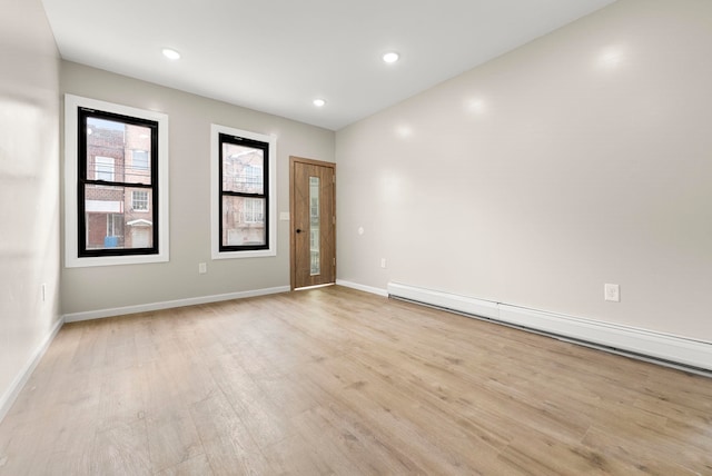 unfurnished room featuring light wood-style flooring, recessed lighting, baseboards, and a baseboard radiator