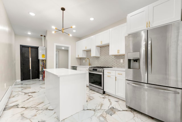 kitchen with light countertops, tasteful backsplash, marble finish floor, and appliances with stainless steel finishes