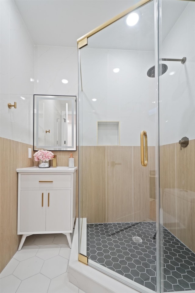 bathroom with vanity, a shower stall, and tile patterned flooring