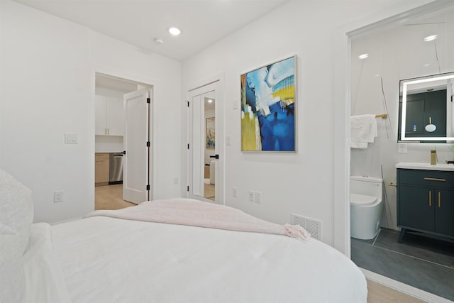 bedroom featuring visible vents, recessed lighting, and ensuite bath