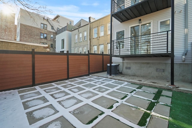 view of patio / terrace featuring a balcony, fence, and central AC