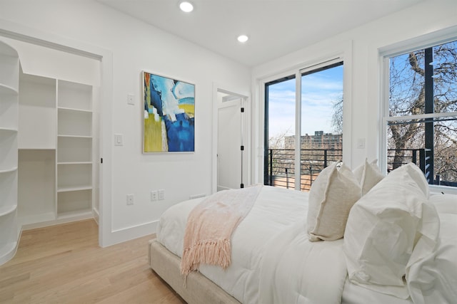 bedroom with access to outside, recessed lighting, light wood-style floors, and baseboards