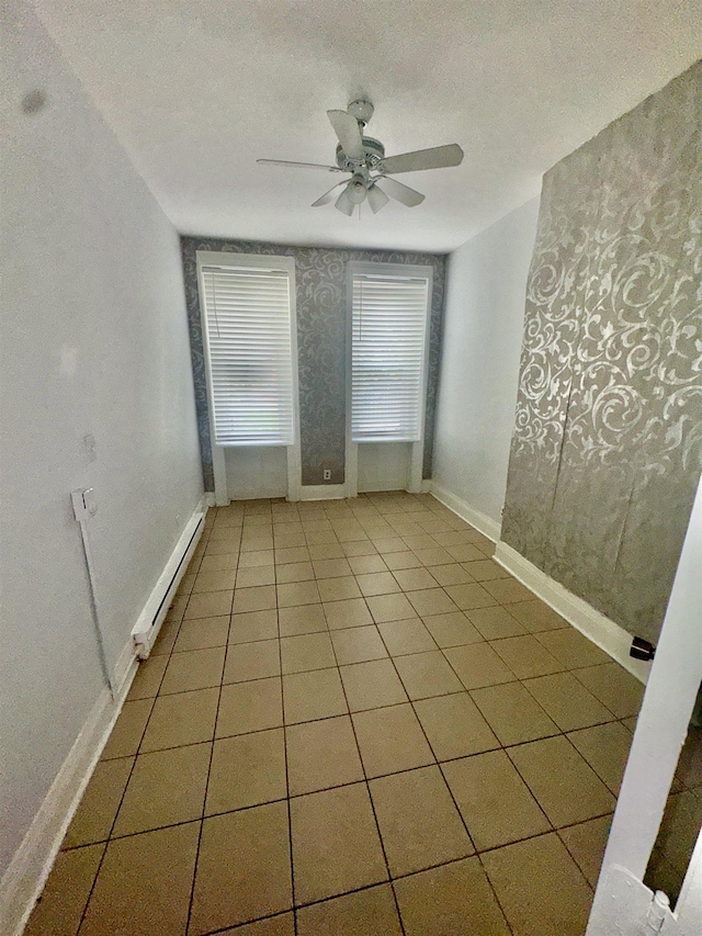 207 15th St, Jersey City, NJ 07310 - unfurnished room with baseboard heating, a ceiling fan, baseboards, light tile patterned floors, and wallpapered walls