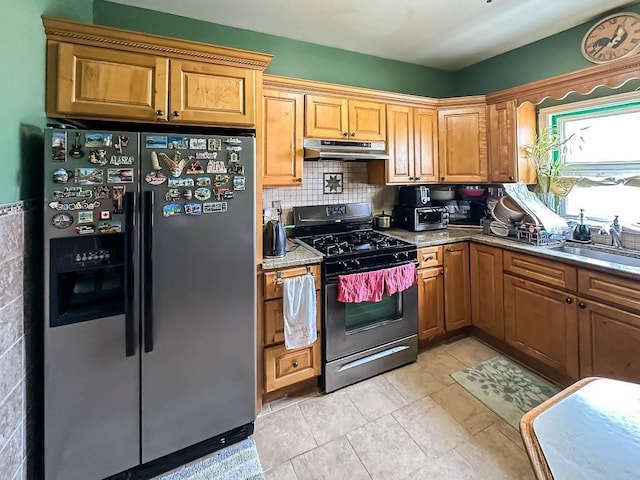 151 Audubon Ave, Jersey City, NJ 07305 - kitchen with stainless steel fridge, under cabinet range hood, gas stove, backsplash, and a sink