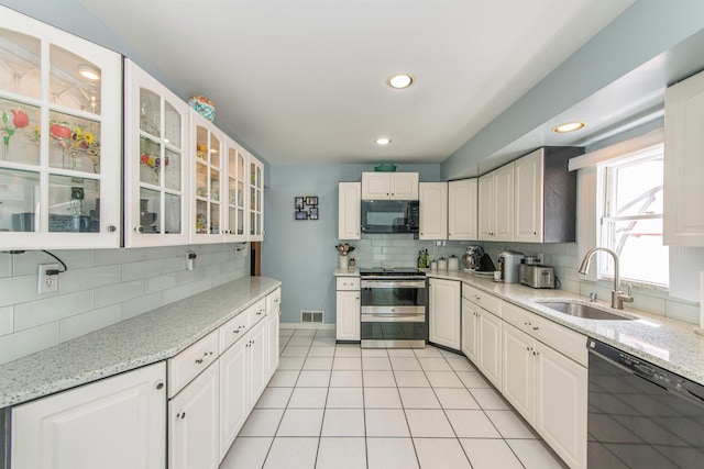 20 Bryant Ave, Bloomfield, NJ 07003 - kitchen with black appliances, backsplash, glass insert cabinets, light stone counters, and white cabinets