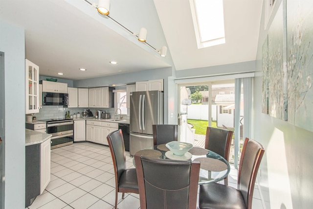 20 Bryant Ave, Bloomfield, NJ 07003 - dining room with light tile patterned floors, a skylight, recessed lighting, and vaulted ceiling